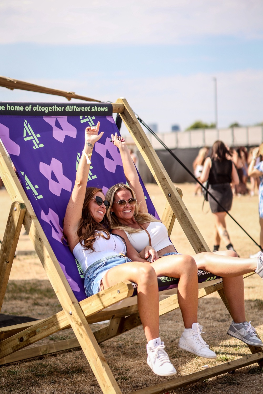 Guests relaxing in an oversized Channel 4 deckchair