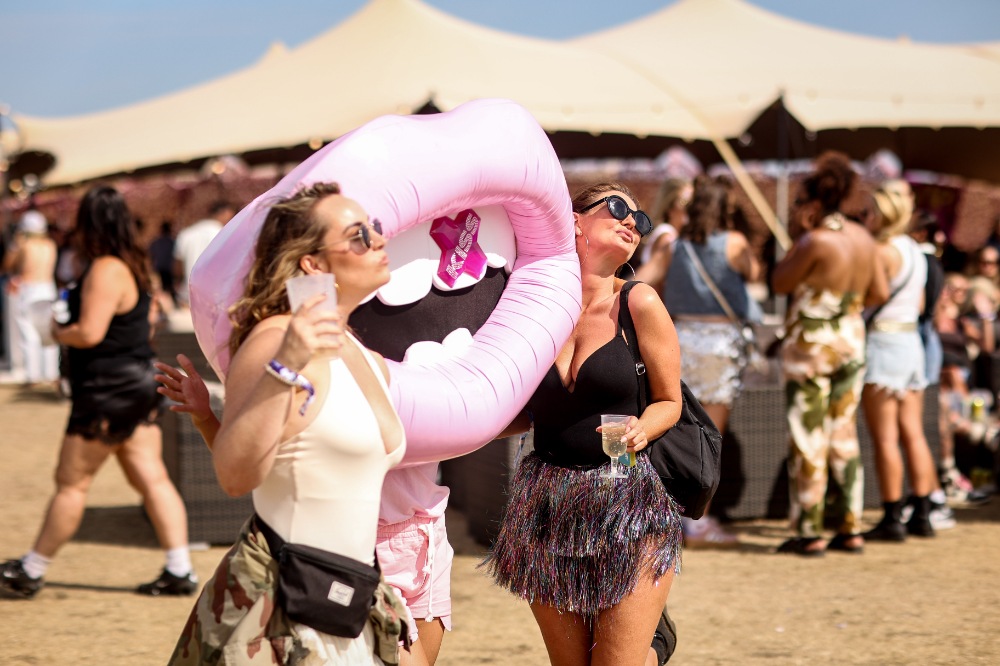 Festival guests interacting with a large KISS lips character