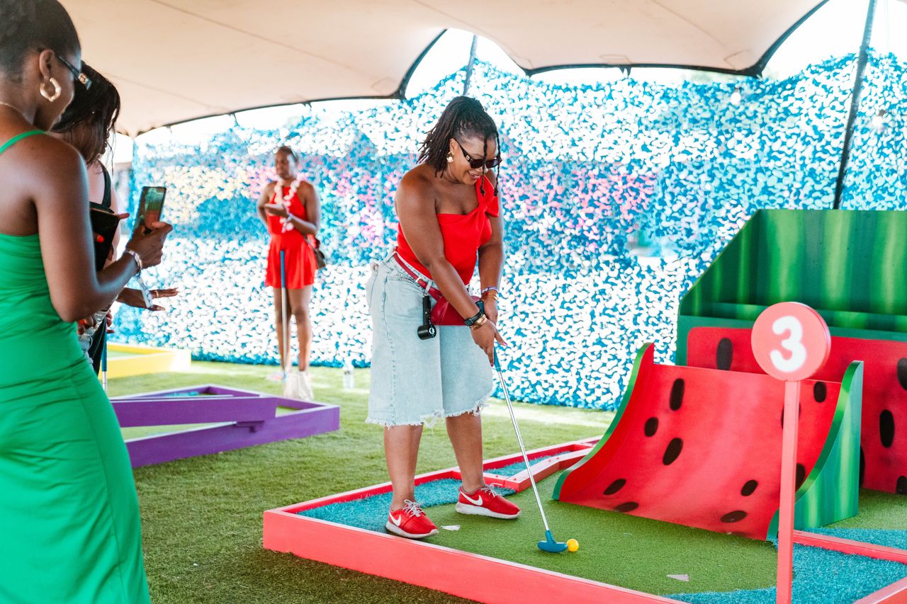 Guest playing on the colourful Mentos crazy golf course