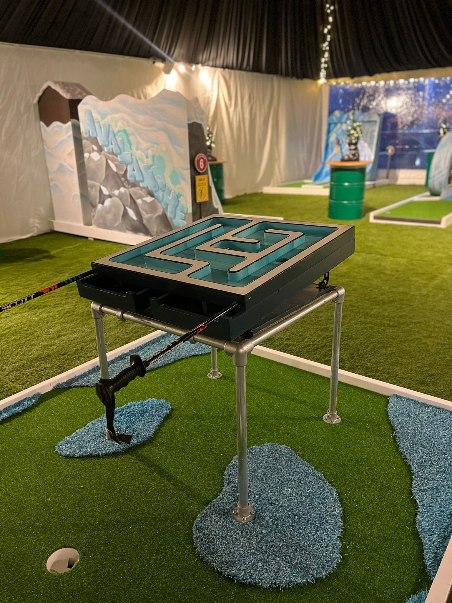 Geometric maze obstacle on a portable golf hole