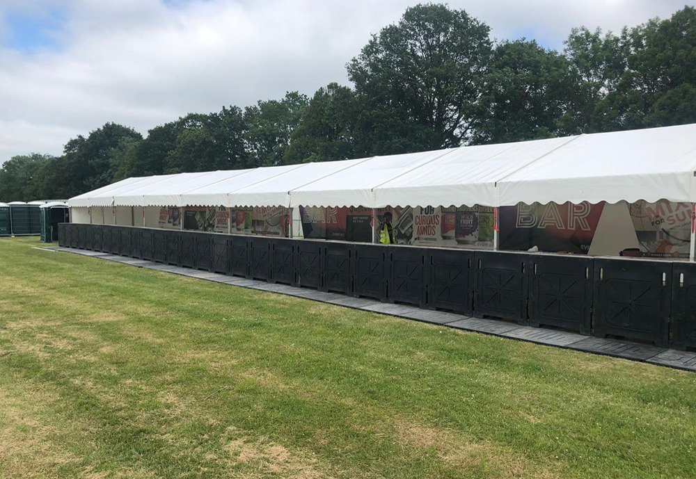 A long temporary bar structure with modular counters and signage