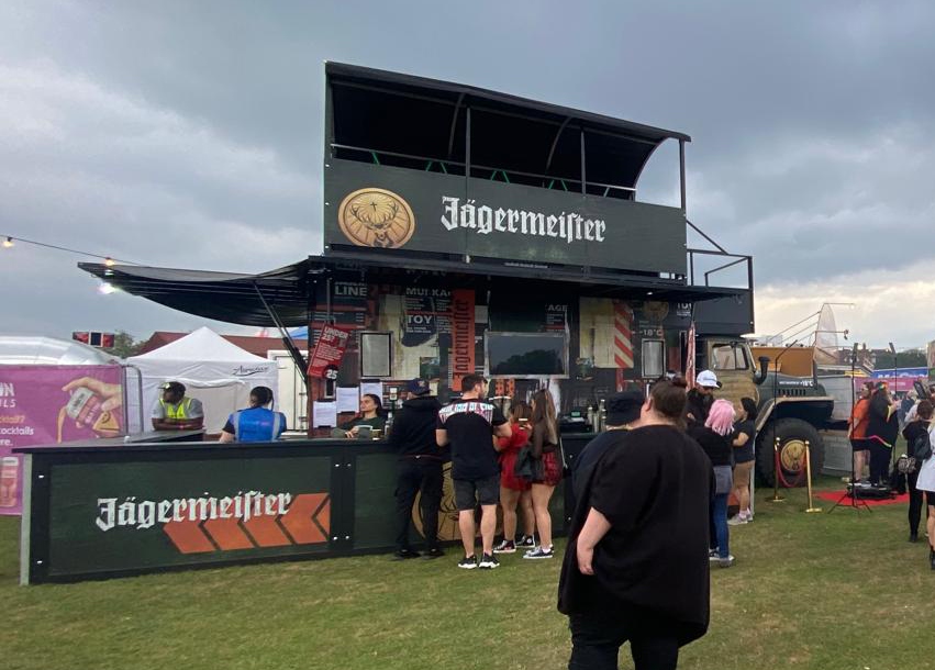 A branded mobile bar structure with large-format signs