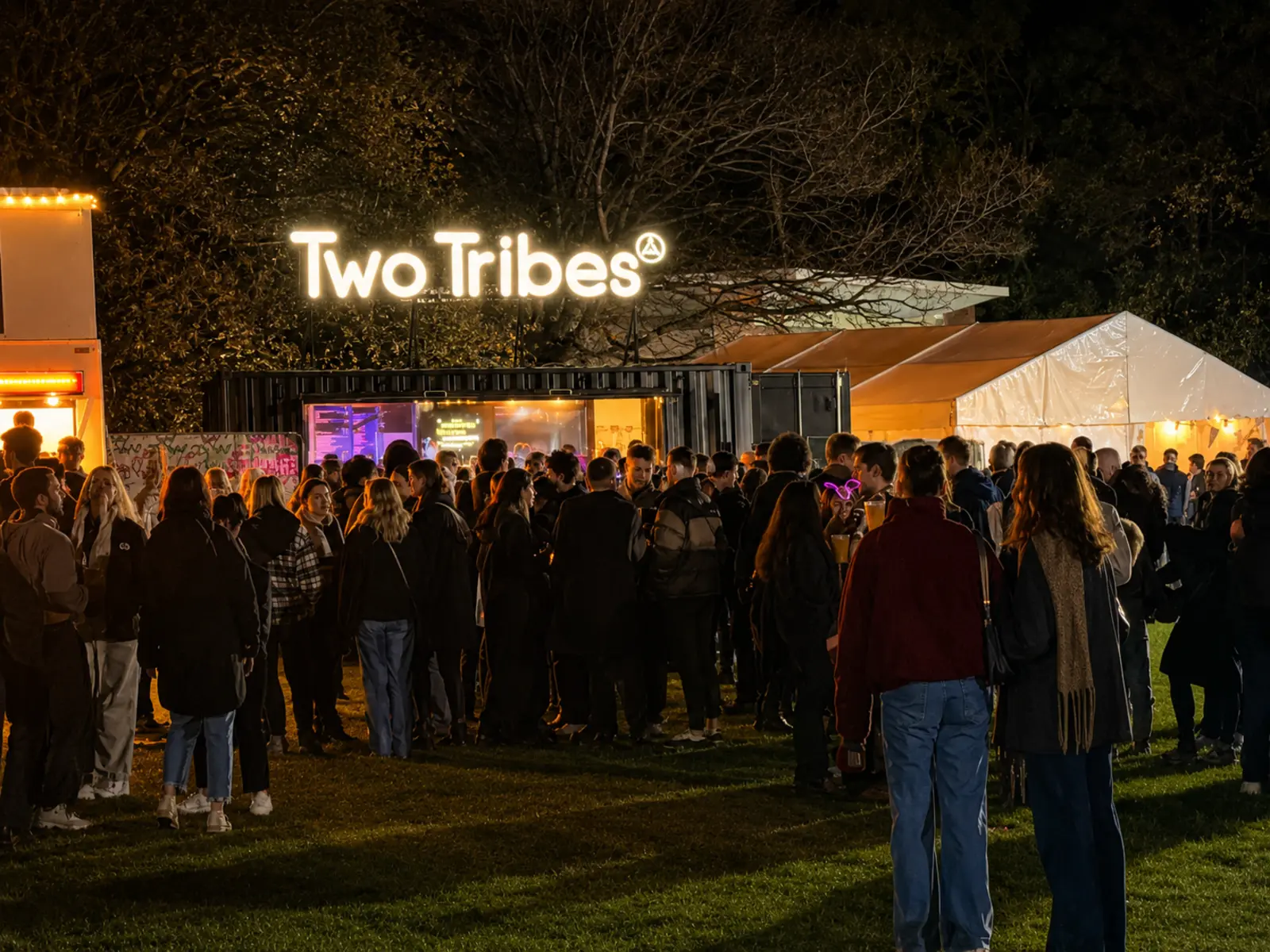 The Two Tribes container bar trading to a busy nighttime crowd